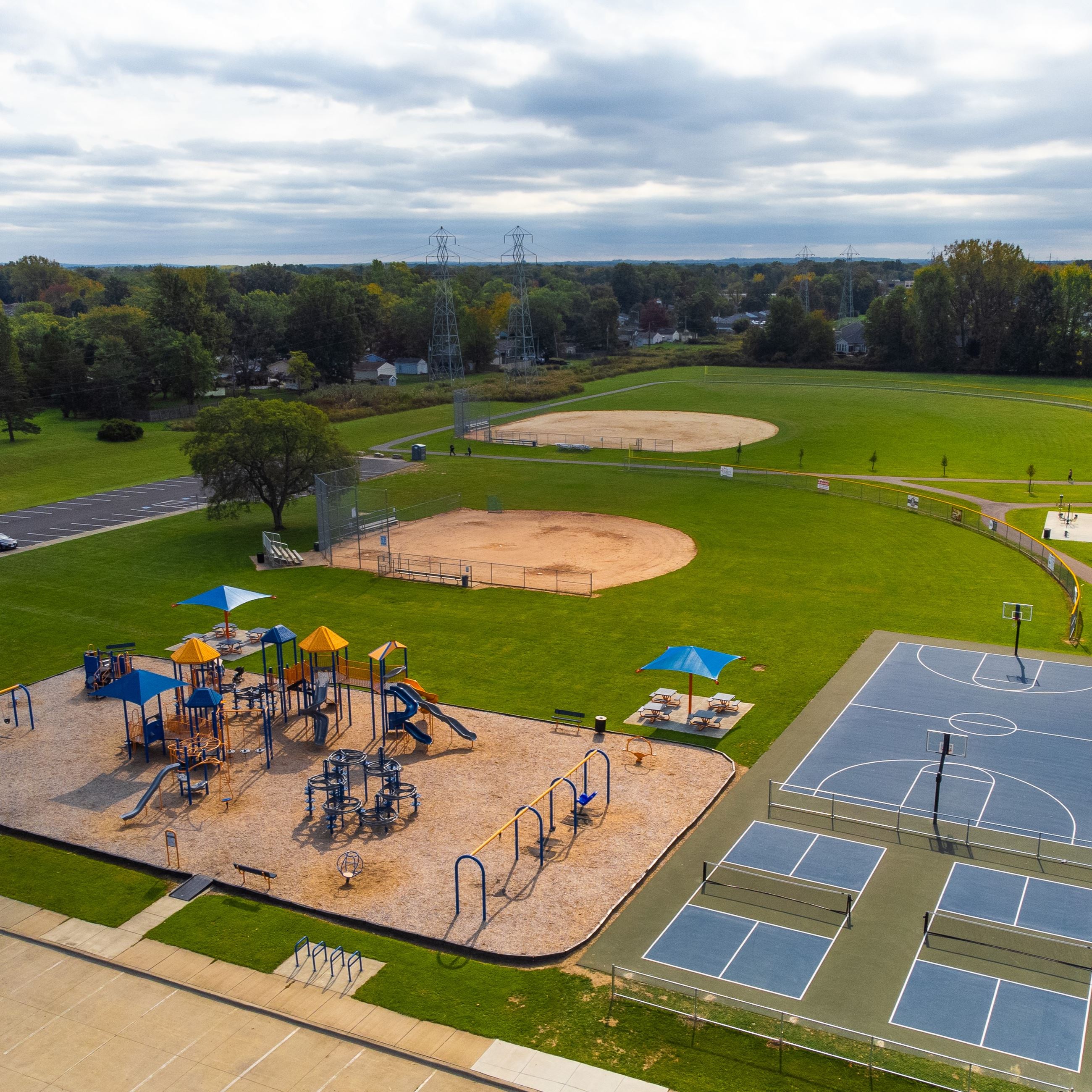 Parknoll Park Drone image of playground, baseball fields, and courts
